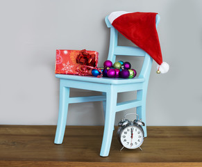 santa claus hat on chair with presents