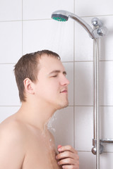 attractive man standing in the shower