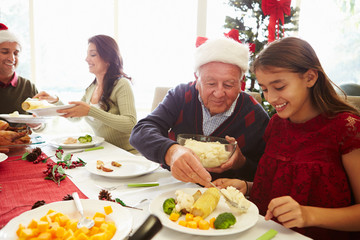 Multi Generation Family Enjoying Christmas Meal At Home