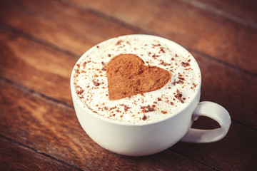 Cup with coffee and shape of the cacao heart on it.
