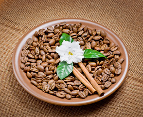 Coffee beans in ceramic plate with flower