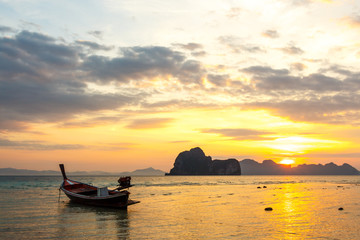 boat on beach and sunrise