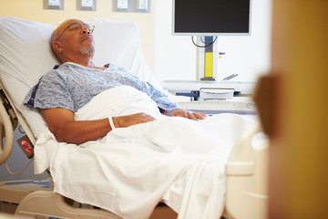 Senior Male Patient Resting In Hospital Bed - Powered by Adobe