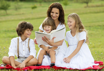 Mother and kids reading a book