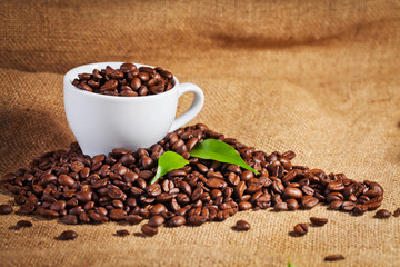coffee cup and arabica beans on cloth sack