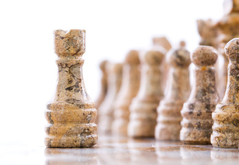 Stone made chess set over white background