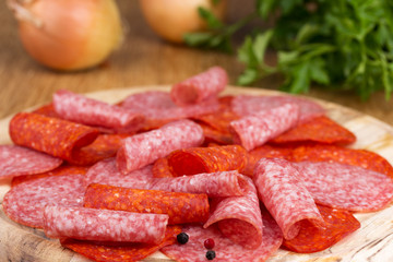 slices of salami with parsley and onions