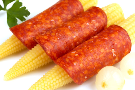 corn wrapped in salami isolated