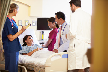 Obraz premium Medical Team Meeting Around Female Patient In Hospital Room