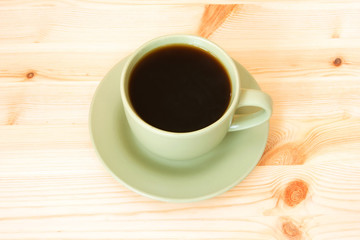 cup of coffee isolated on a wooden background