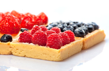 Shortcakes with berries on white background