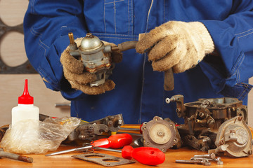 Mechanic repairing the old car engine fuel pump