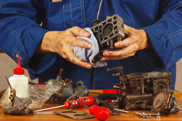 Repair of details old automotive engine in the workshop