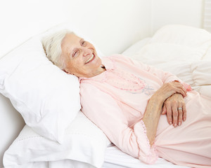 Beddridden senior citizen woman smiling