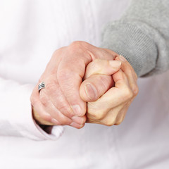 Happy senior couple holding hands