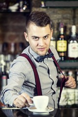 young man working as a bartender in a nightclub bar