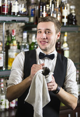young man working as a bartender in a nightclub bar