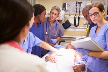 Medical Team Working On Patient In Emergency Room
