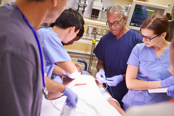 Medical Team Working On Patient In Emergency Room