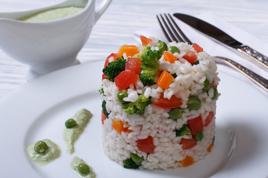 Vegetable risotto with sauce on the table