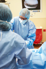 Surgical Team Working In Operating Theatre