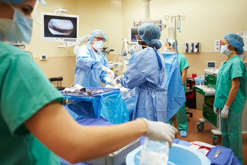 Surgical Team Working In Operating Theatre