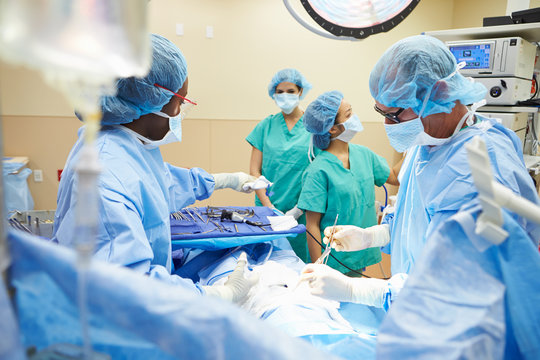 Surgical Team Working In Operating Theatre