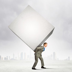 Businessman carrying cube