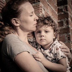 sad son hugging his mother