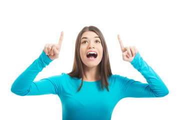 Beautiful casual woman pointing on copy space.