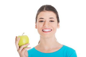 Beautiful casual woman holding an apple.