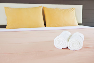 style bedroom interior with White towels and double yellow pillo