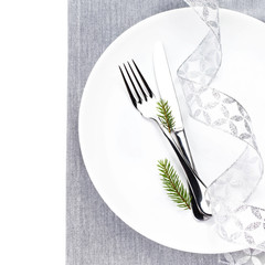 Christmas table setting in white and silver with christmas decor
