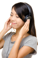 Naklejka premium Asian woman listen to music