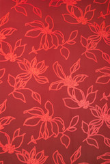 Fototapeta na wymiar An exotic red color floral pattern weaved fabric as textural