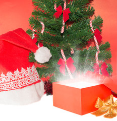 Gift and Santa Claus hat under christmas tree