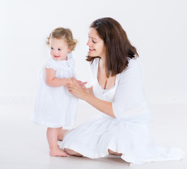 Beautiful mother and toddler daughter having fun together