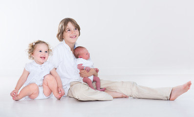Portrait of siblings, school age boy, toddler sister and newborn