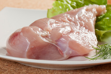 Raw chicken breast with the other components of the food.