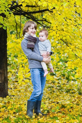 Fototapeta premium Two kids, cute boy and his baby sister walking in an autumn park