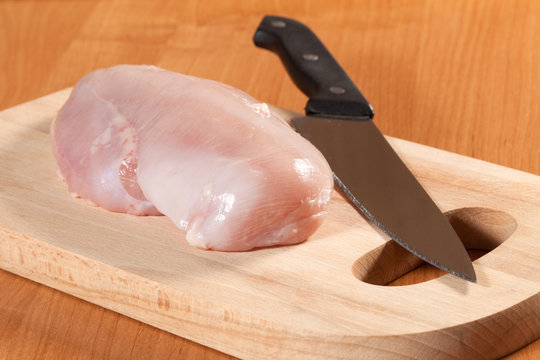 Raw chicken breast with the other components of the food.