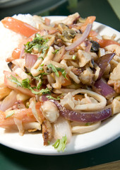mariscos saltados Peruvian seafood fried in tomatoes onion  fren