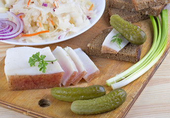 Marinated cabbage (sauerkraut), pickled cucumber,pieces of lard