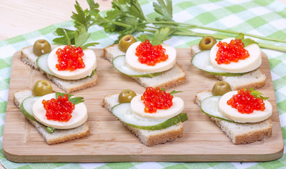 Sandwiches of white bread with  salmon caviar