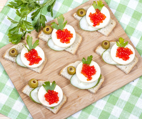 Sandwiches of white bread with fresh cucumber, cheese,  salmon c