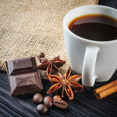 Cup of coffee with brown sugar on a wooden table.