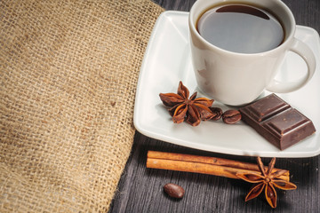 Cup of coffee with brown sugar on a wooden table.