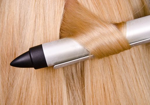 Curler and blond hair in the hairdresser saloon.