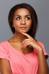 Cheerful young black woman isolated on grey background