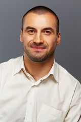 Handsome man in white shirt isolated on grey background